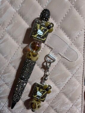 Black and tan rhinestone pen and matching phone charm.